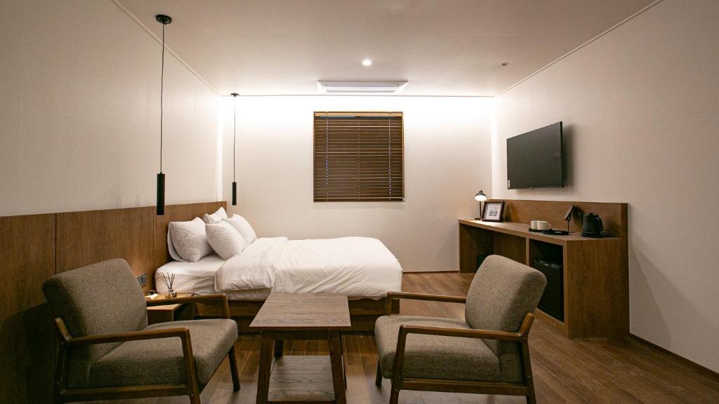 Postel nebo postele na pokoji v ubytování Hotel Yimok