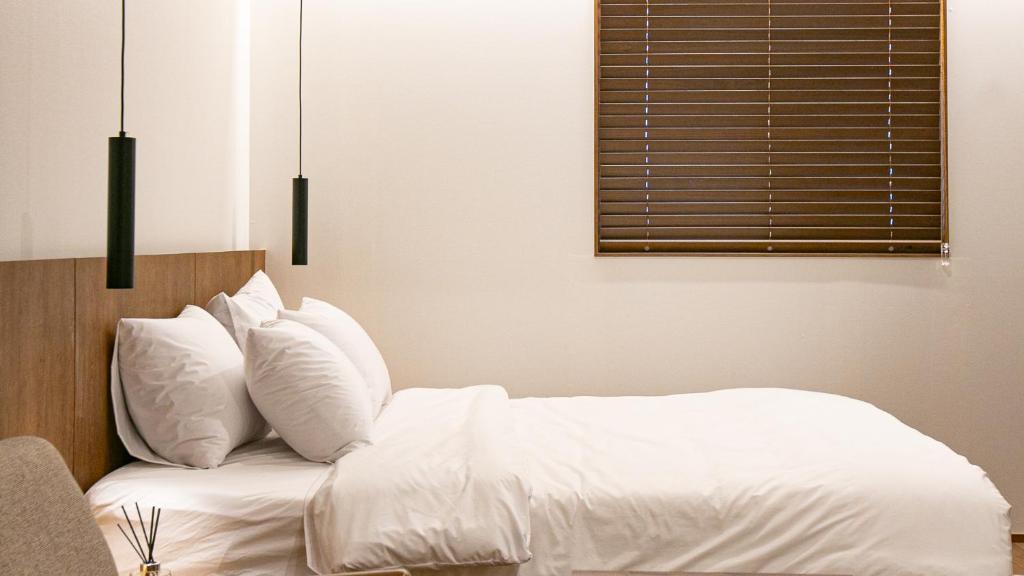 Postel nebo postele na pokoji v ubytování Hotel Yimok