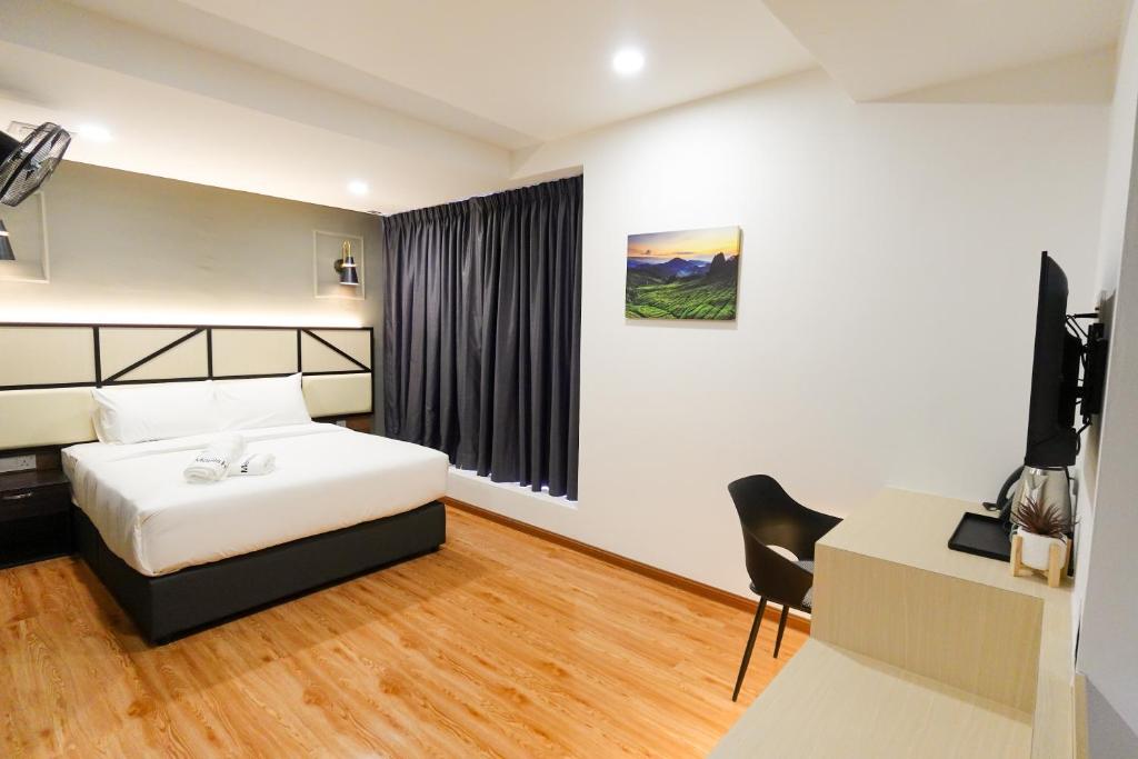 Postel nebo postele na pokoji v ubytování Merits Hotel Cameron Highlands