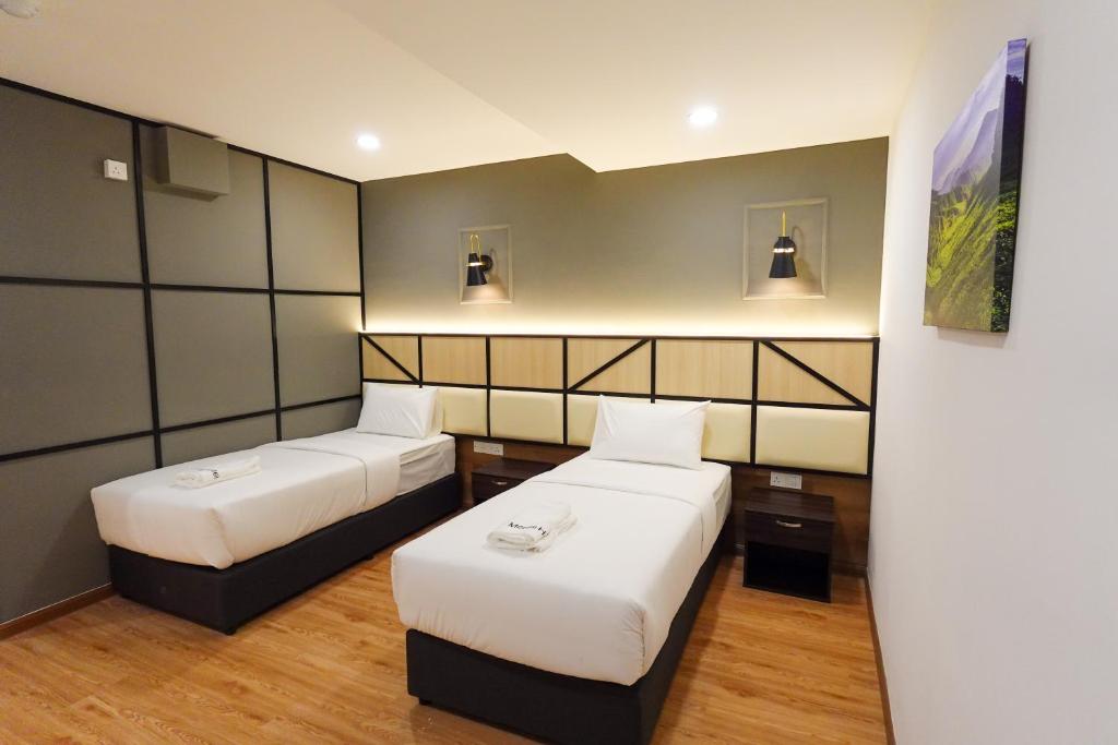 Postel nebo postele na pokoji v ubytování Merits Hotel Cameron Highlands