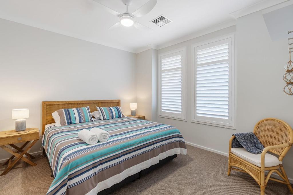 a bedroom with a bed and a chair and a window at Shepherds Delight-Access Friendly-Linen Included in Goolwa South