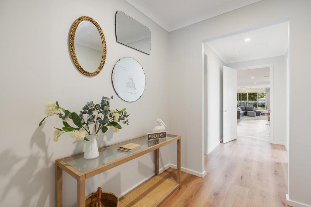 a living room with a table and a mirror at Shepherds Delight-Access Friendly-Linen Included in Goolwa South