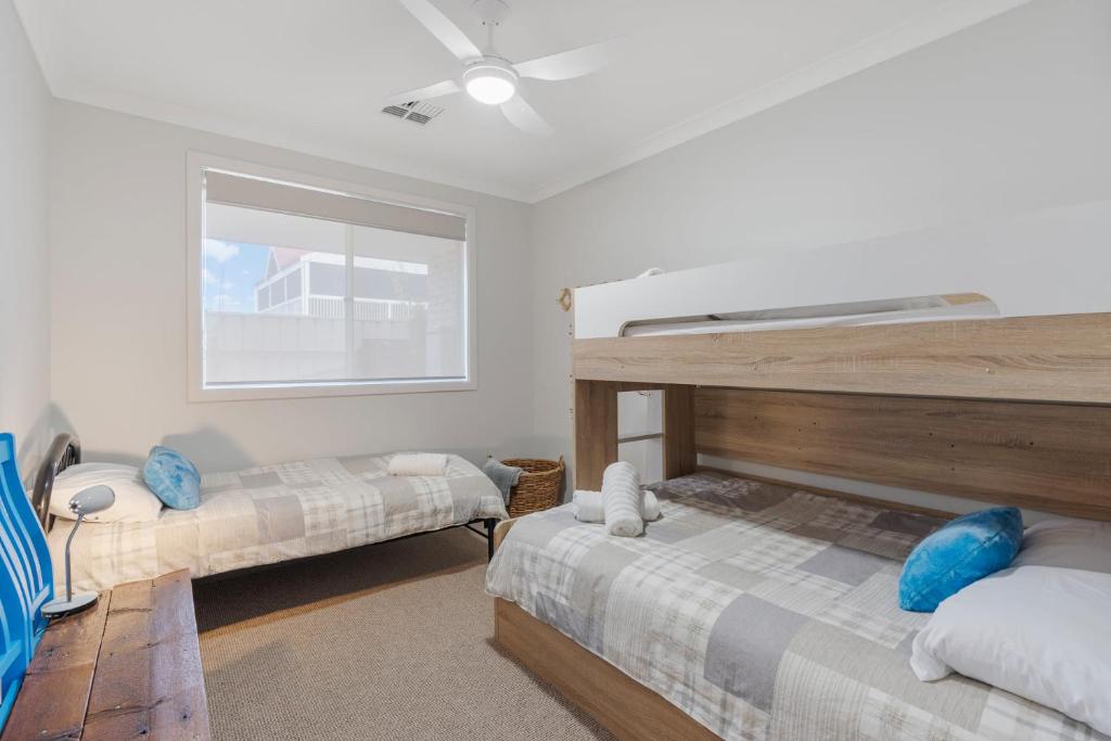 a bedroom with two bunk beds and a window at Shepherds Delight-Access Friendly-Linen Included in Goolwa South
