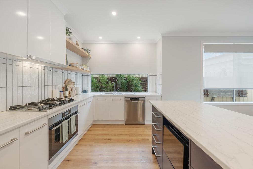 a kitchen with white cabinets and a counter top at Shepherds Delight-Access Friendly-Linen Included in Goolwa South