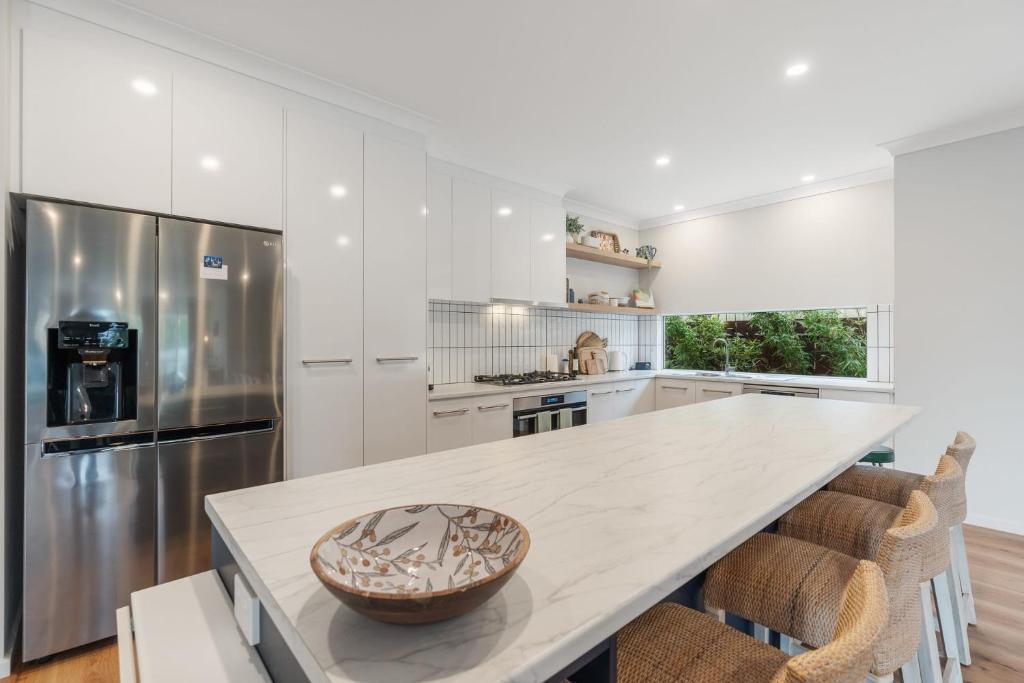 a white kitchen with a large white counter top at Shepherds Delight-Access Friendly-Linen Included in Goolwa South