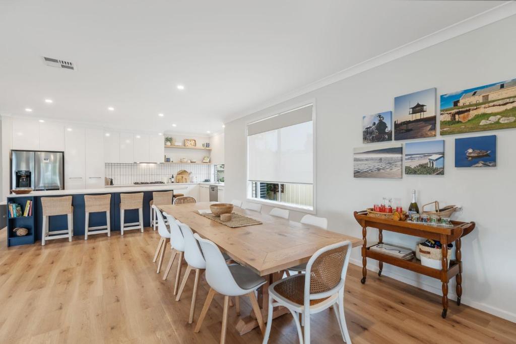 a kitchen and dining room with a wooden table and chairs at Shepherds Delight-Access Friendly-Linen Included in Goolwa South