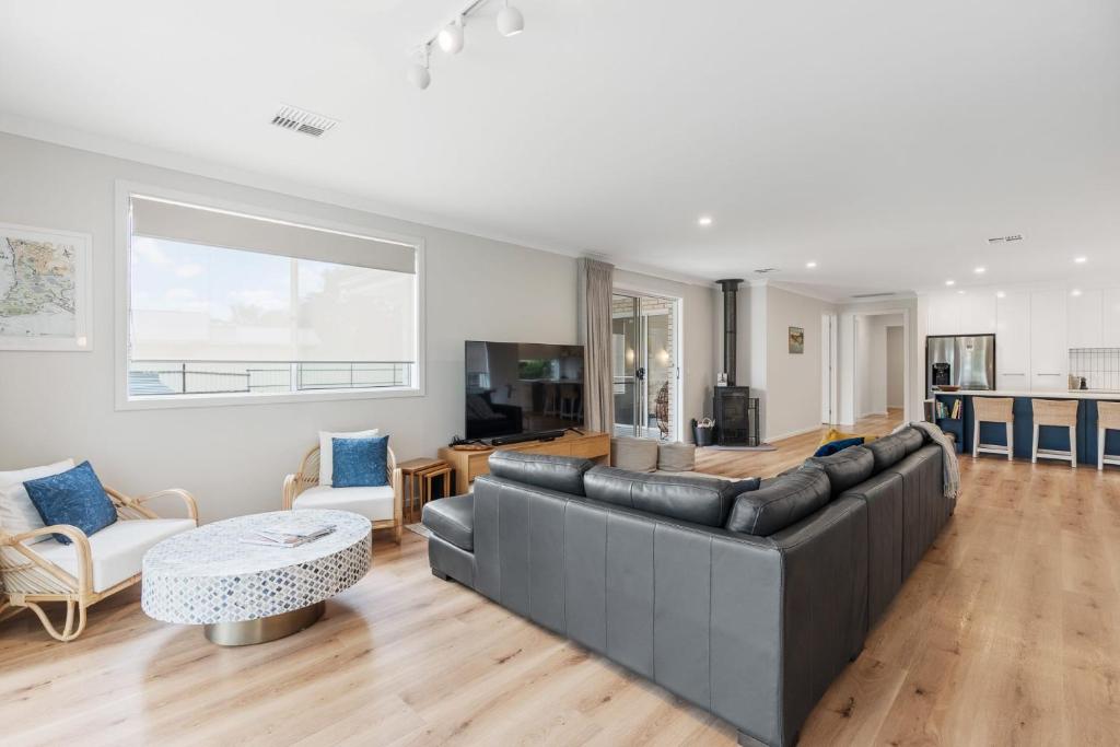 a living room with a couch and a table at Shepherds Delight-Access Friendly-Linen Included in Goolwa South