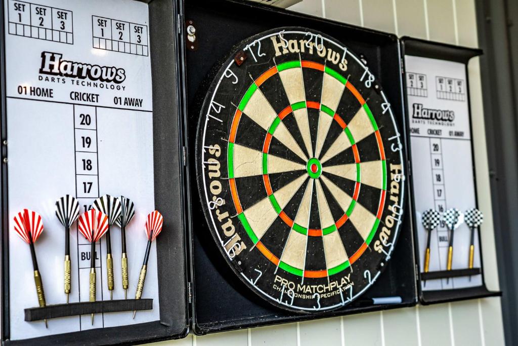 a dart board on a wall with darts at Shepherds Delight-Access Friendly-Linen Included in Goolwa South