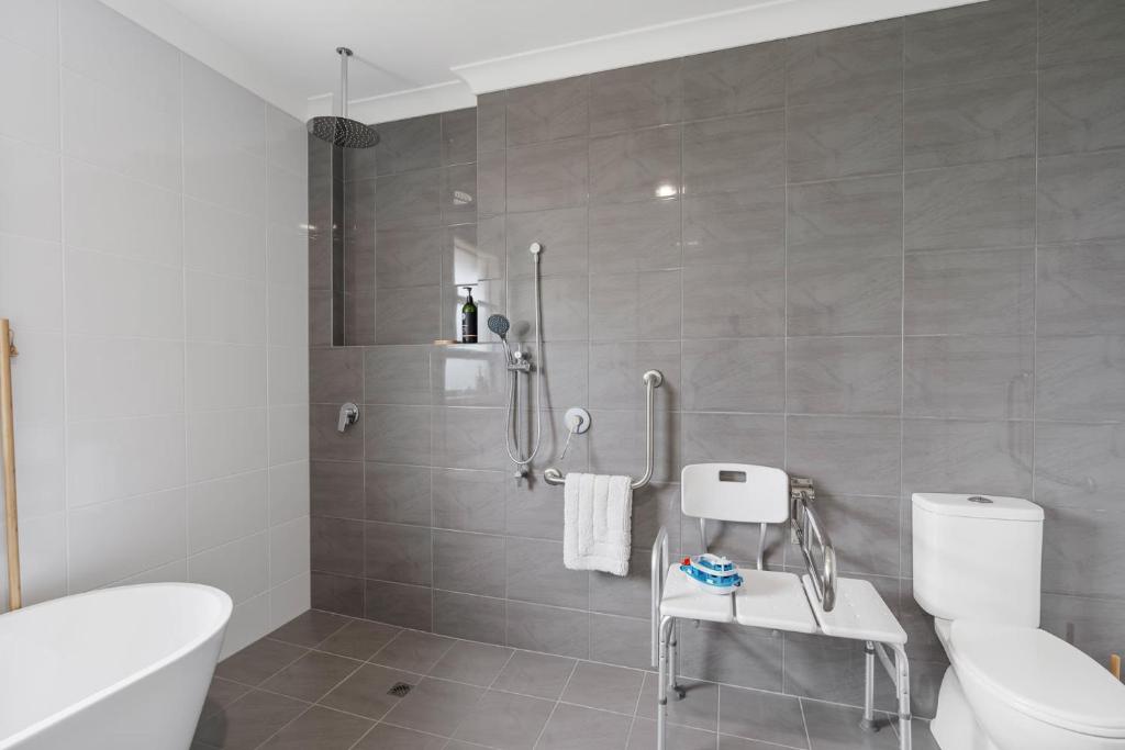 a bathroom with a white toilet and a shower at Shepherds Delight-Access Friendly-Linen Included in Goolwa South