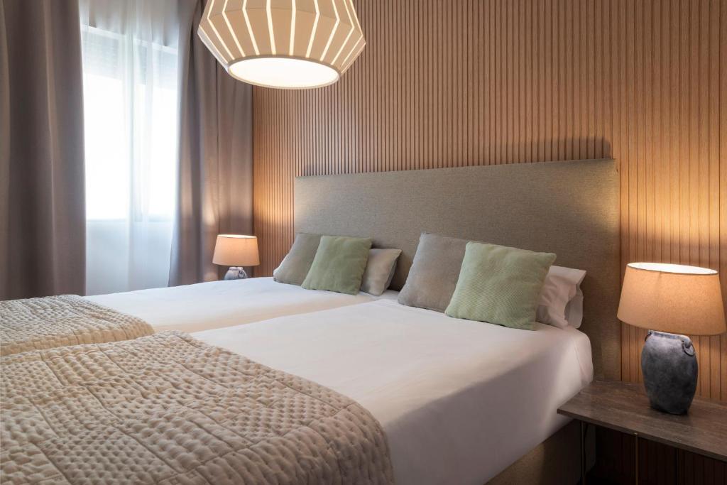 Posteľ alebo postele v izbe v ubytovaní Magno Apartments Muñoz Olivé