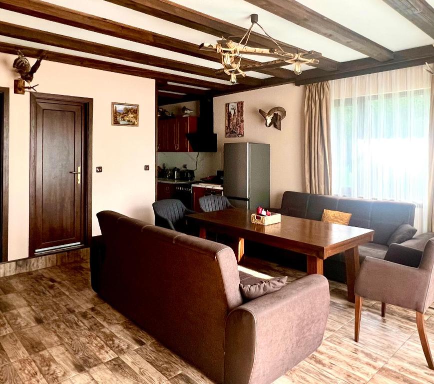 a living room with a couch and a table at Villa Capricorn in Tsigov Chark