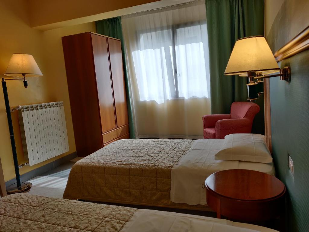 Postel nebo postele na pokoji v ubytování Albergo Conte Max