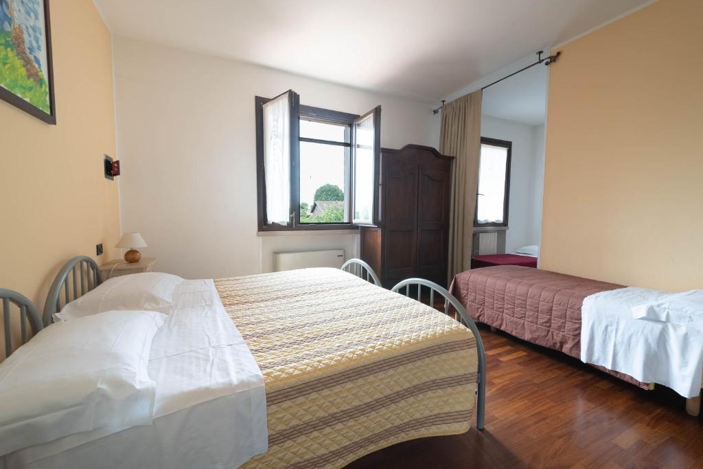 Postel nebo postele na pokoji v ubytování Agriturismo Bortolino