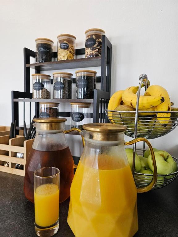 two bottles of juice and a glass of orange juice at Hotel Fuchs & Hase SELF CHECK IN in Rosegg