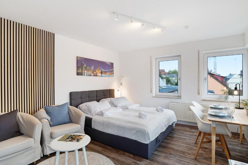a bedroom with a bed and a living room at Nette kompakte Wohnung mit Balkon in Pforzheim