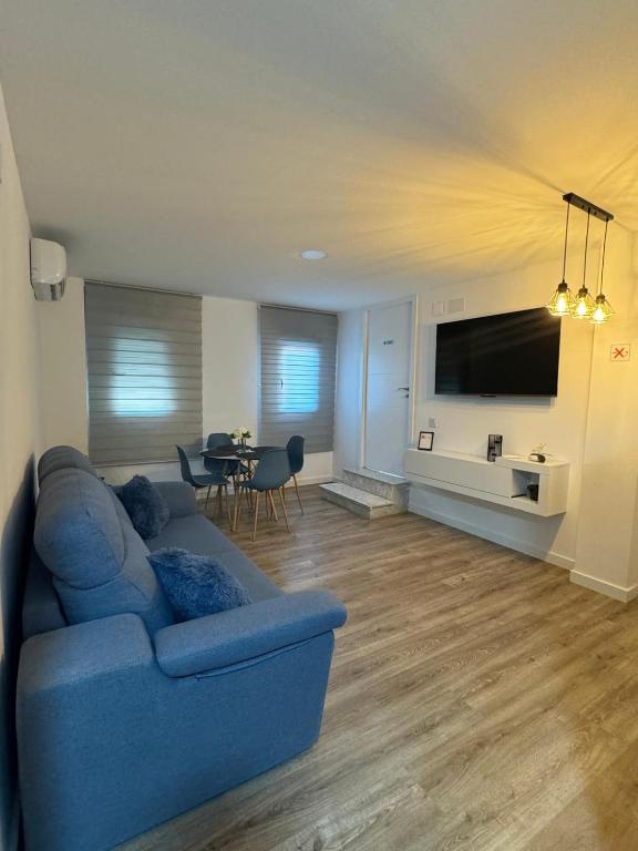 a living room with a blue couch and a table at Linerlife in Málaga