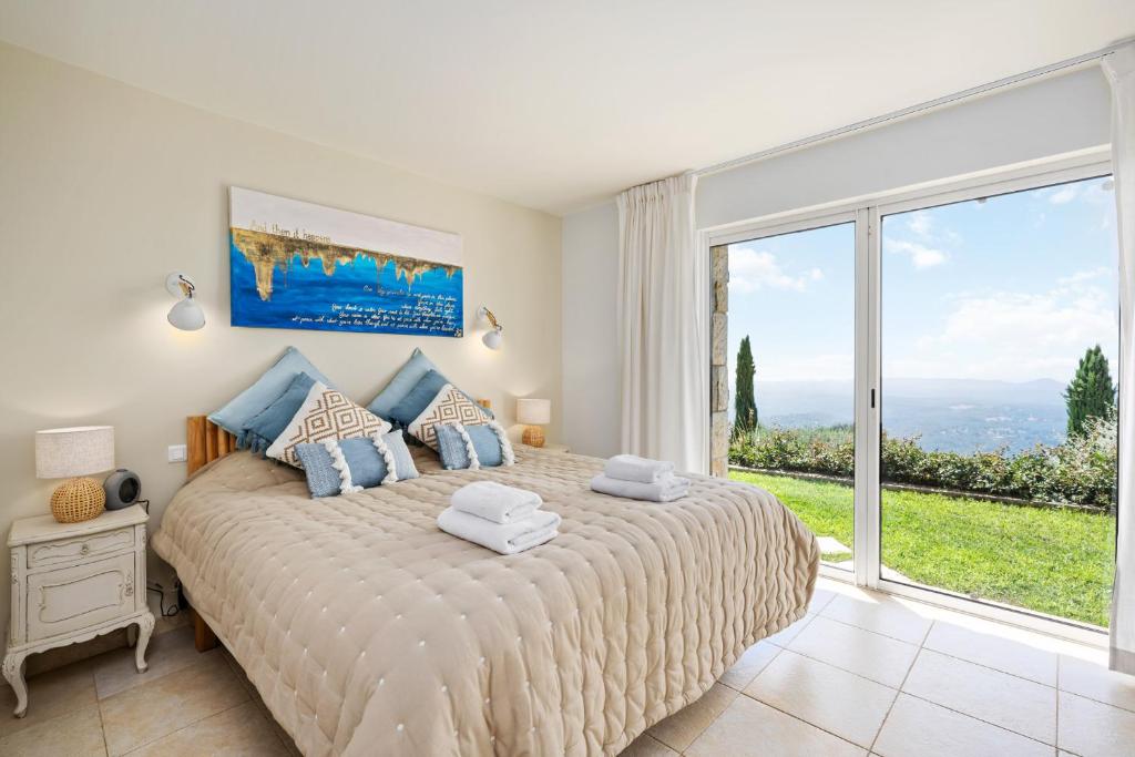 Ein Bett oder Betten in einem Zimmer der Unterkunft Villa La Genestière - Familienoase und Golfertraum mit Infinity-Pool und 180-Grad-Panoramablick bis zum Meer