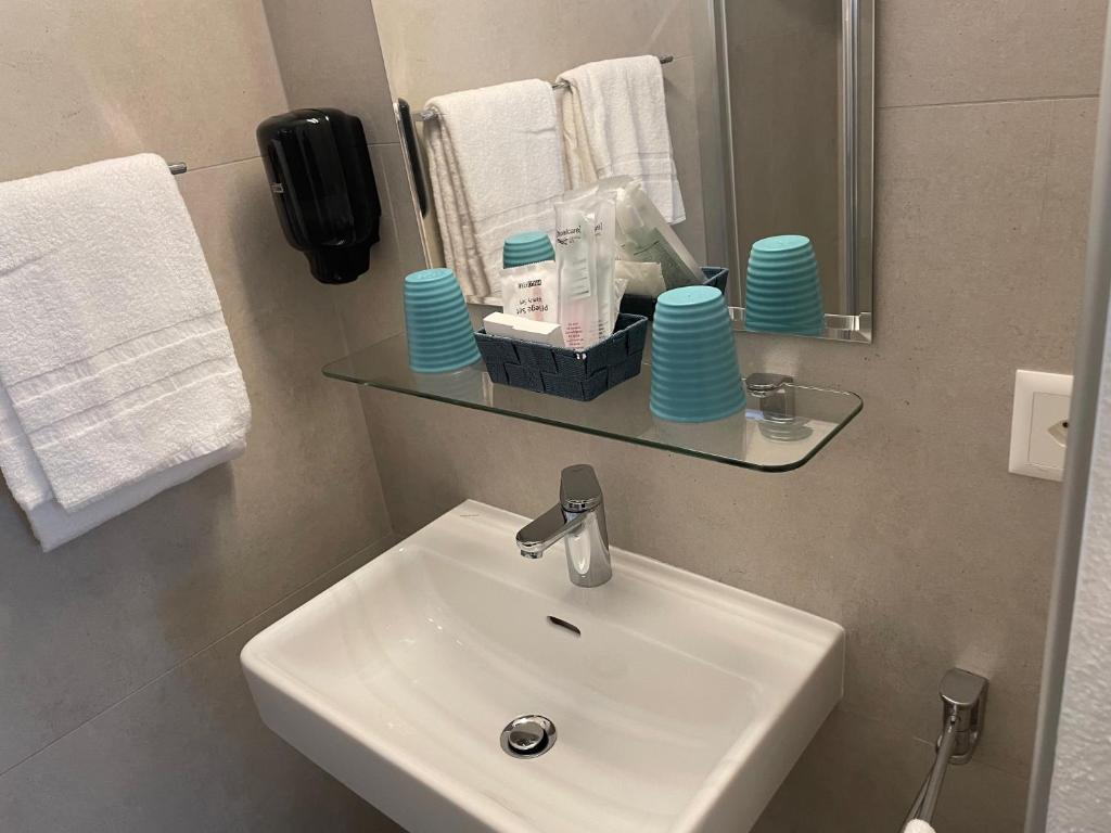 a bathroom with a sink and a mirror at Eh!Toi Self Motel in Etoy