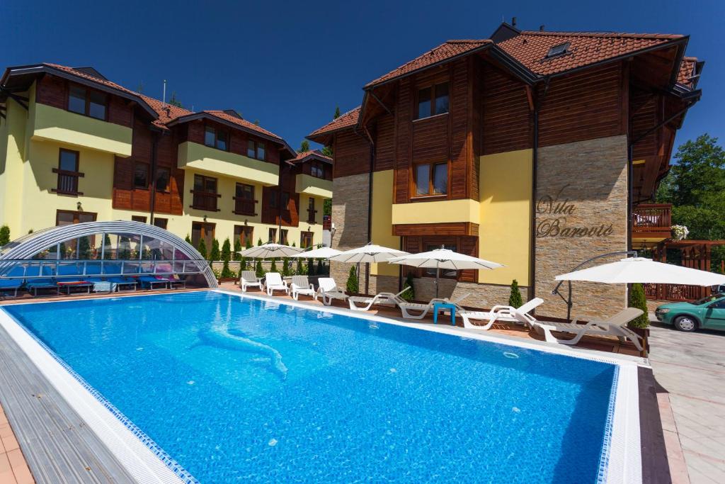 a large swimming pool in front of a building at Vila Barović and Spa in Zlatibor