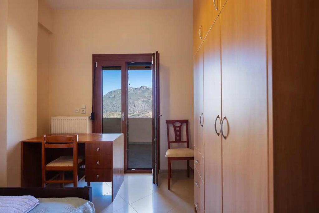 a bedroom with a desk and a table and a chair at Camellia in Saktoúria