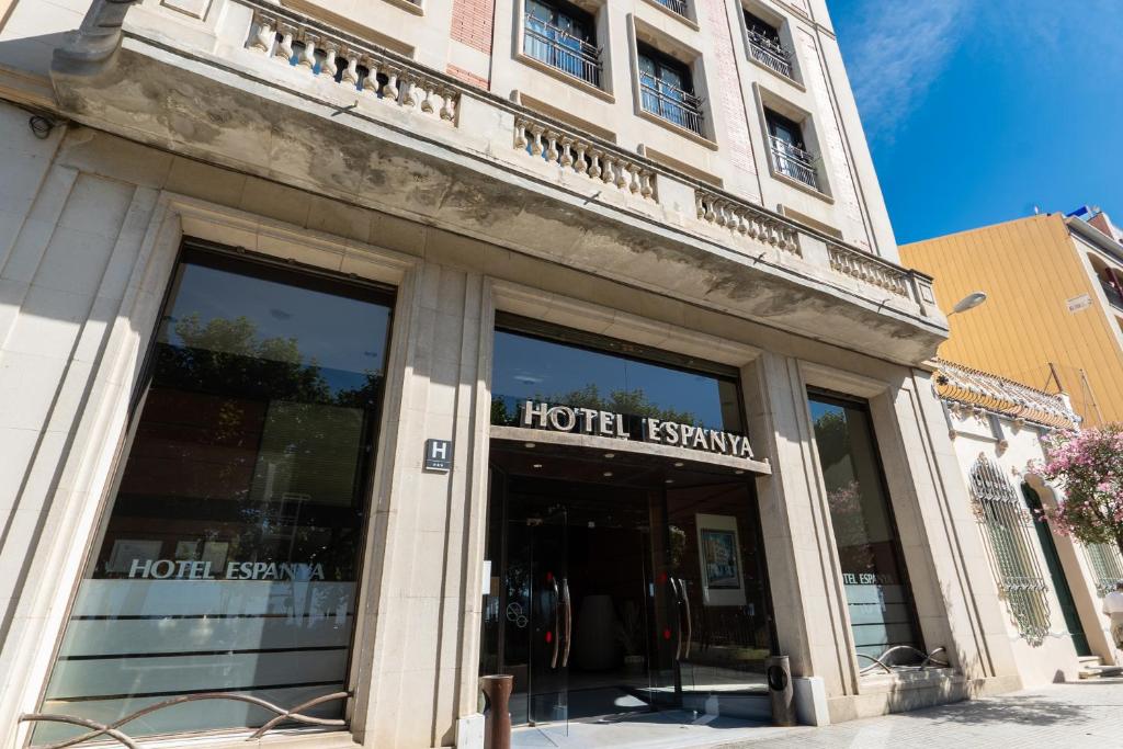a store front of a building with glass windows at Hotel Espanya by ALEGRIA in Calella