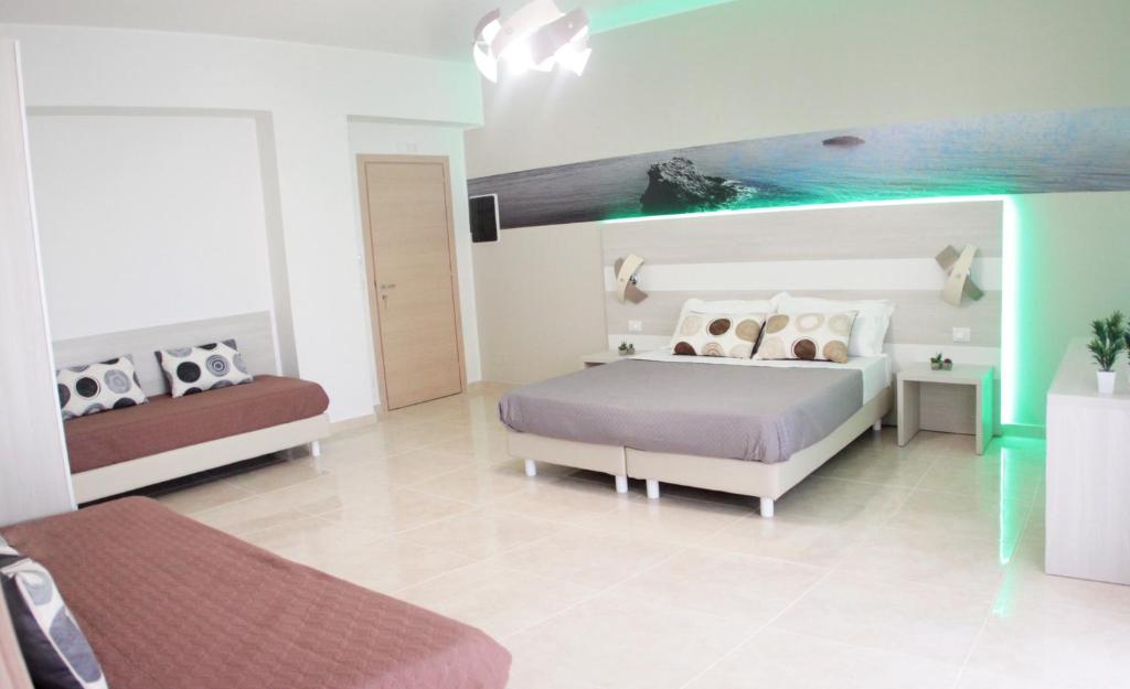 Postel nebo postele na pokoji v ubytování A'MANTIA HOTEL