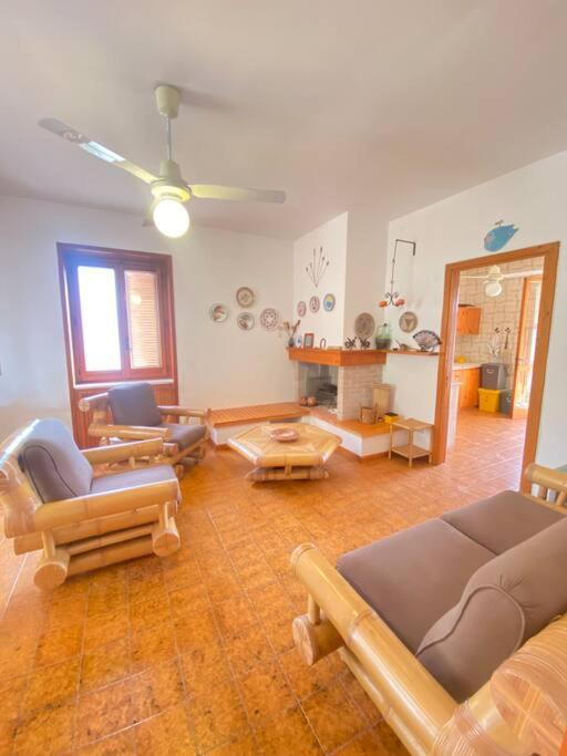 a living room with chairs and a couch and a table at Casa del Fico in Santa Caterina di Nardò