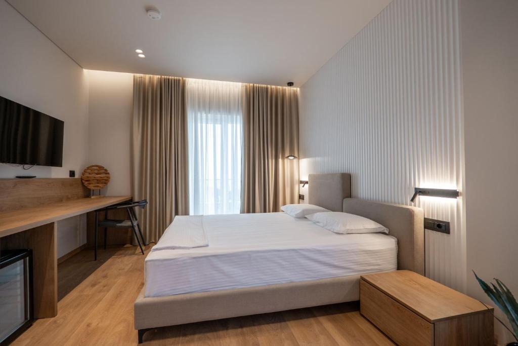 Postel nebo postele na pokoji v ubytování Kamara Rooms