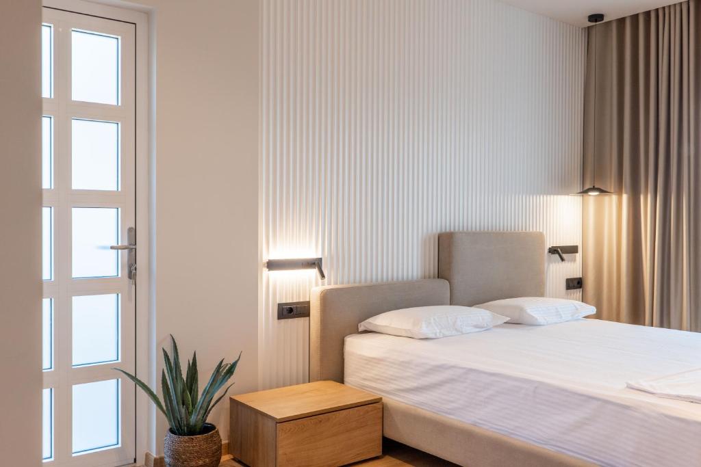 Postel nebo postele na pokoji v ubytování Kamara Rooms