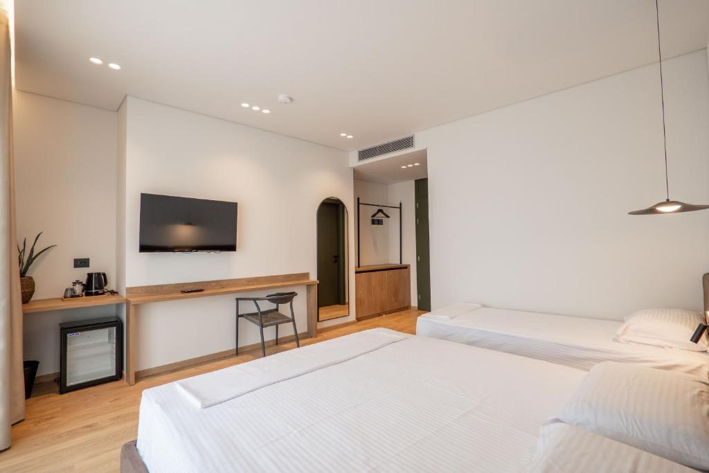 Postel nebo postele na pokoji v ubytování Kamara Rooms