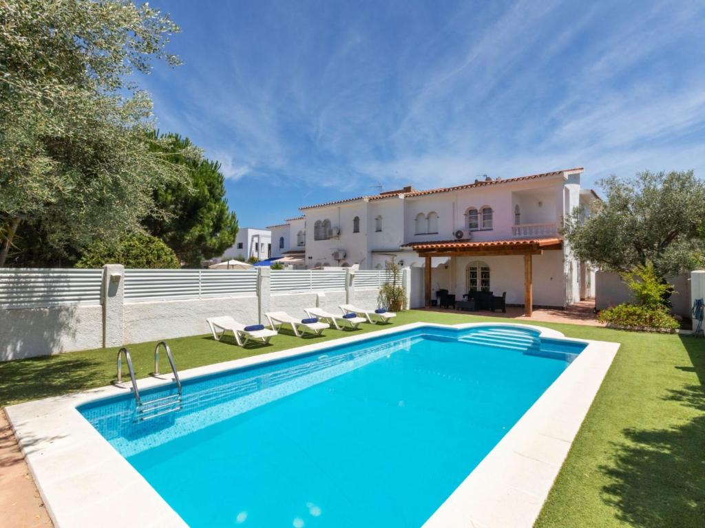 a villa with a swimming pool and a house at Holiday Home Salze by Interhome in Hospitalet de l'Infant