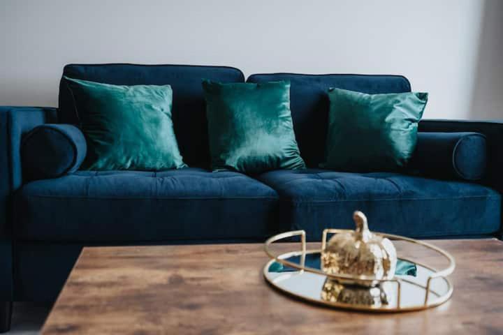 a living room with a blue couch and a table at Westminster Luxury Liverpool Apartment with Free Parking in Liverpool