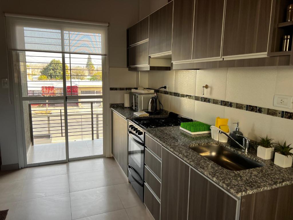 a kitchen with a sink and a counter top at Departamento en Mendoza in Guaymallen