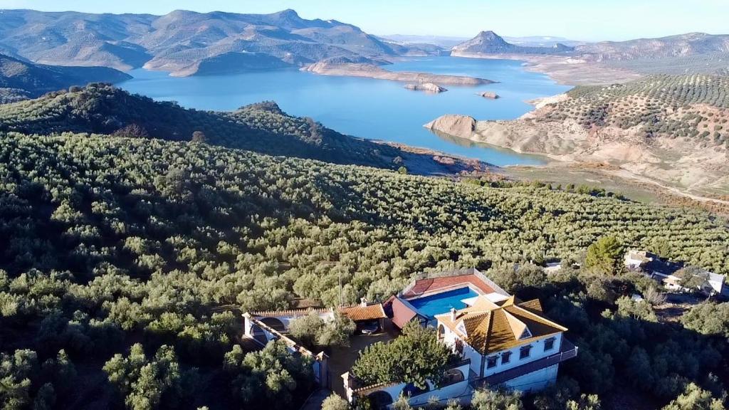 an aerial view of a house with a lake at La Villa del Lago in Iznájar
