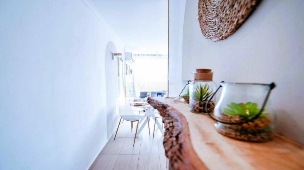 a living room with a fish bowl on a wooden table at Horizonte beachfront apartment in Ifach