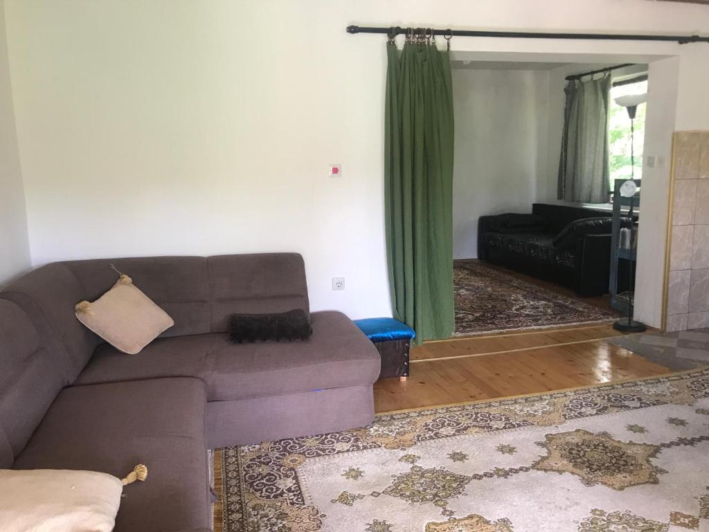 a living room with a couch and a mirror at Kokin Brod Apartments in Kokin Brod
