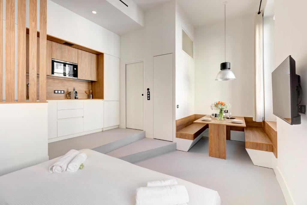 Cette chambre comprend un lit, un bureau et une télévision. dans l'établissement Immogroom - 2 min du palais - Studio - Luxury - AC, à Cannes