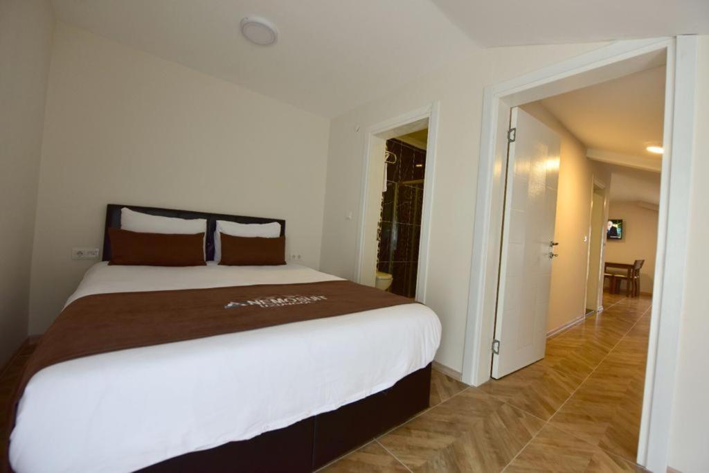 A bed or beds in a room at Anemo Suite