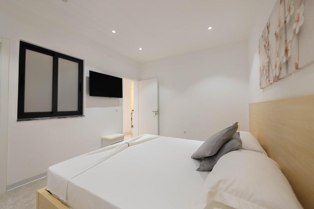 Postel nebo postele na pokoji v ubytování ViVi Aparthotel