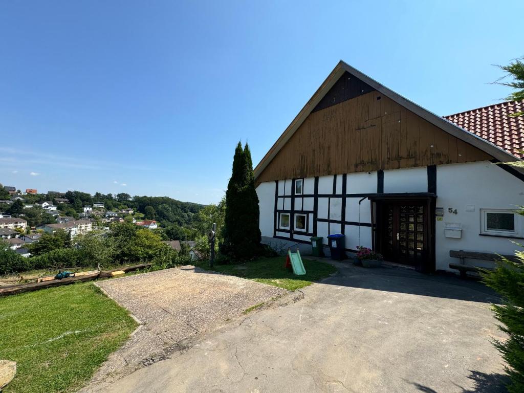 a large white building with a wooden roof at Altes Bauernhaus in der Natur in Detmold