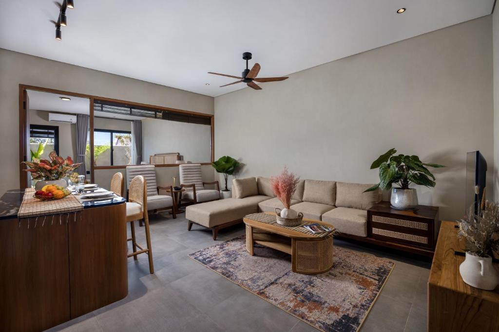 a living room with a couch and a table at Canggu Bagus Suites in Canggu