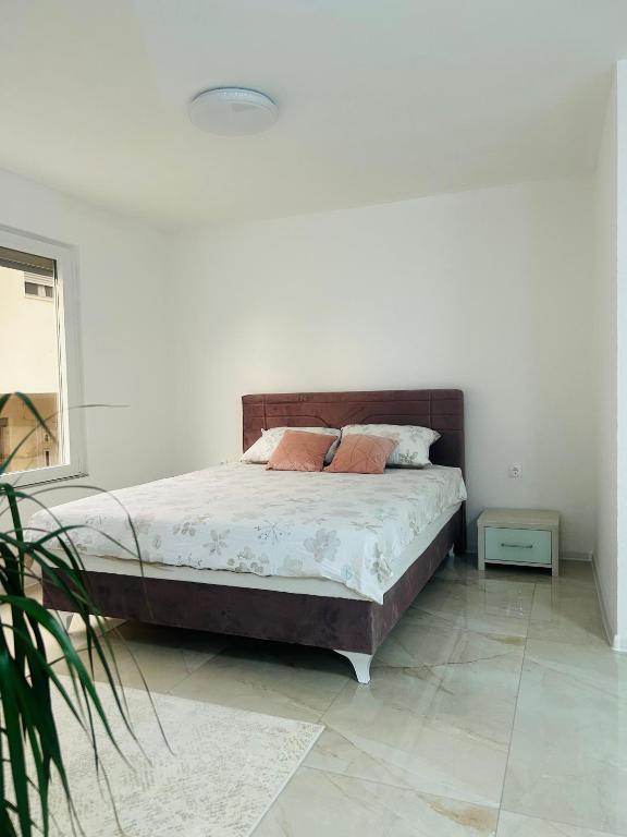 a bedroom with a bed with two pillows on it at Apartman Zen in Bihać