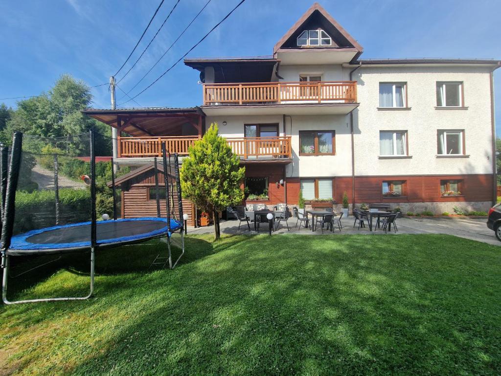a house with a playground in front of it at Willa Justynka in Krynica Zdrój