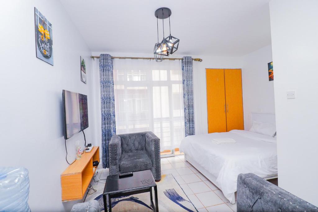 una camera con letto, scrivania e sedia di Serene studio along Ngong road-Nairobi a Nairobi