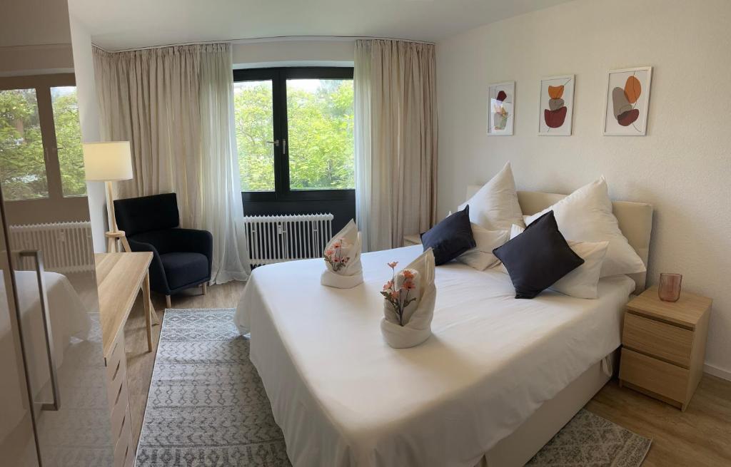 a bedroom with a large white bed with flowers on it at Medina in Düsseldorf