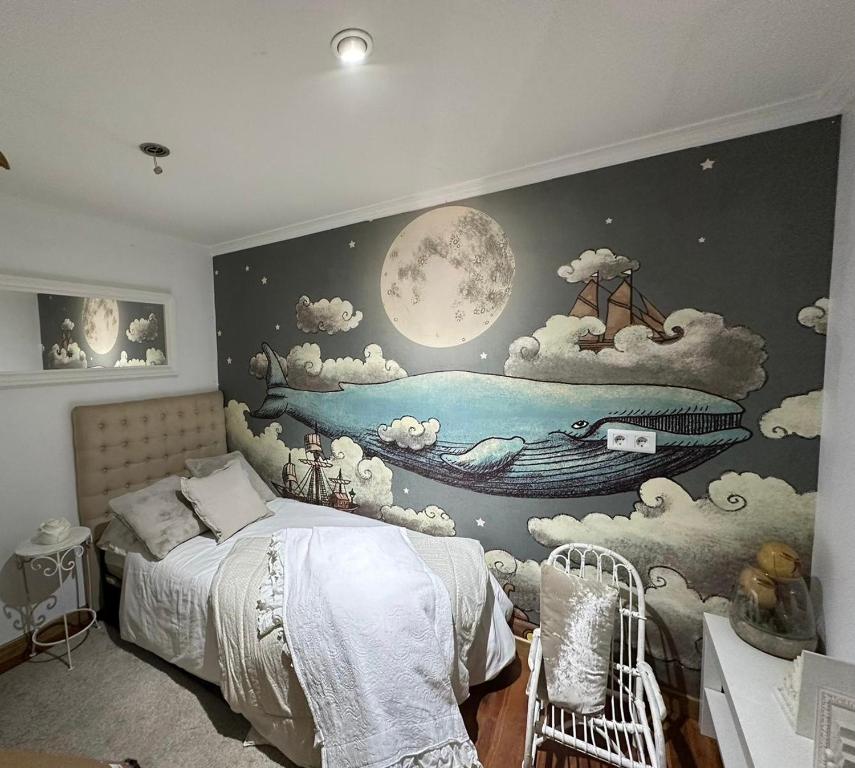 a bedroom with a wall mural of a boat in the water at Mar de Alcabre in Vigo