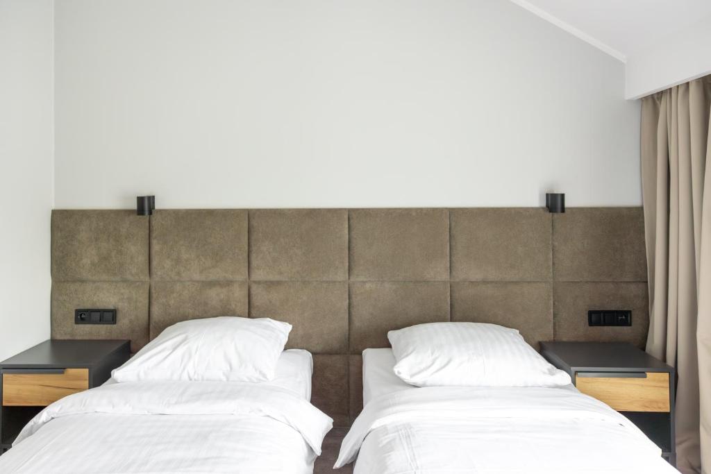 Posteľ alebo postele v izbe v ubytovaní Hotel Mały Młyn