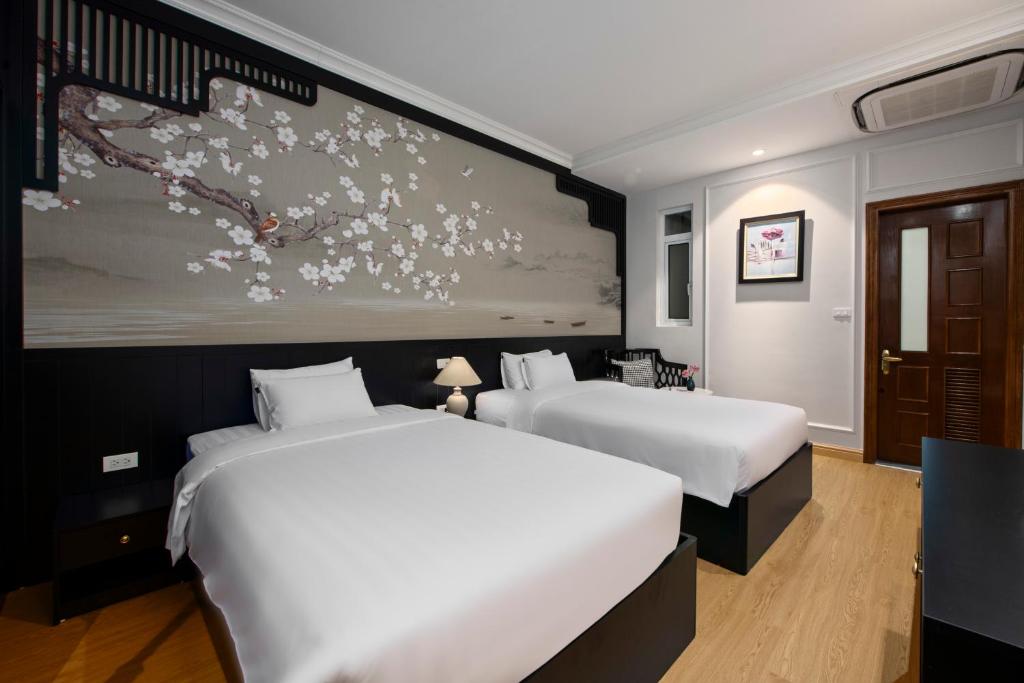 Postel nebo postele na pokoji v ubytování Serenata San de Hanoi Hotel