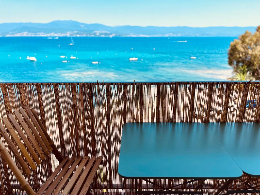 a table and two chairs with a view of the ocean at Front de mer Beau T3 climatisé Balcon Parking Ajaccio in Ajaccio