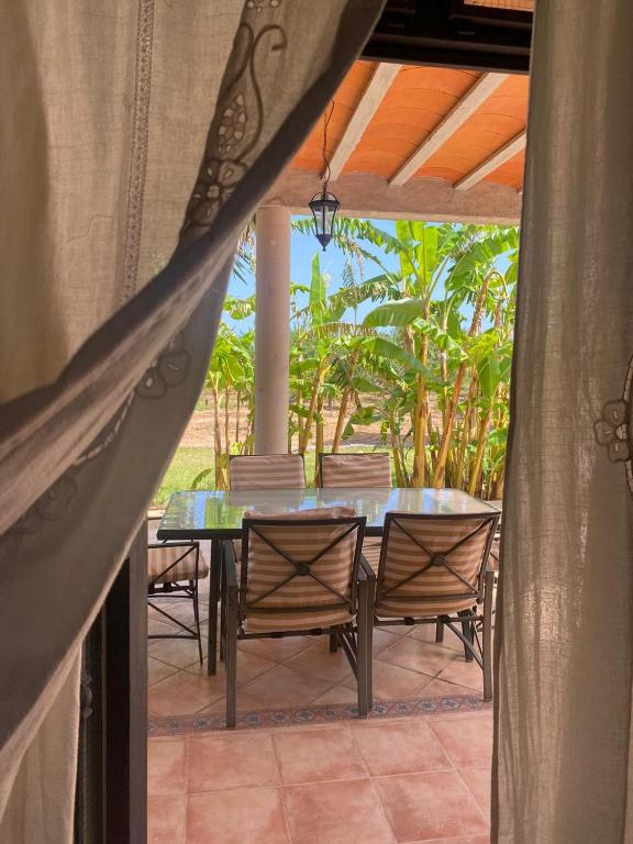 a patio with a table and chairs on a patio at Los Almendros in Torrenostra